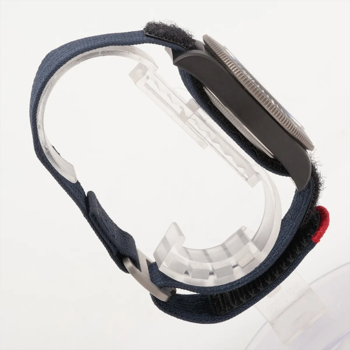 Diver's watch with a dark carbon case, blue dial and matching fabric strap.