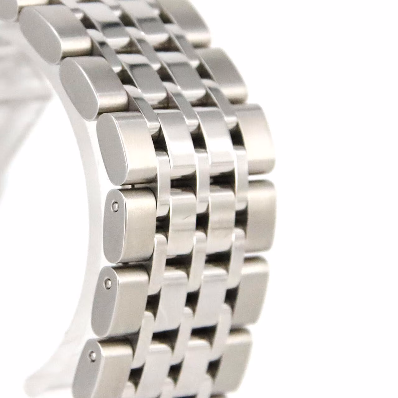 Steel bracelet watch with a round polished case and light dial.