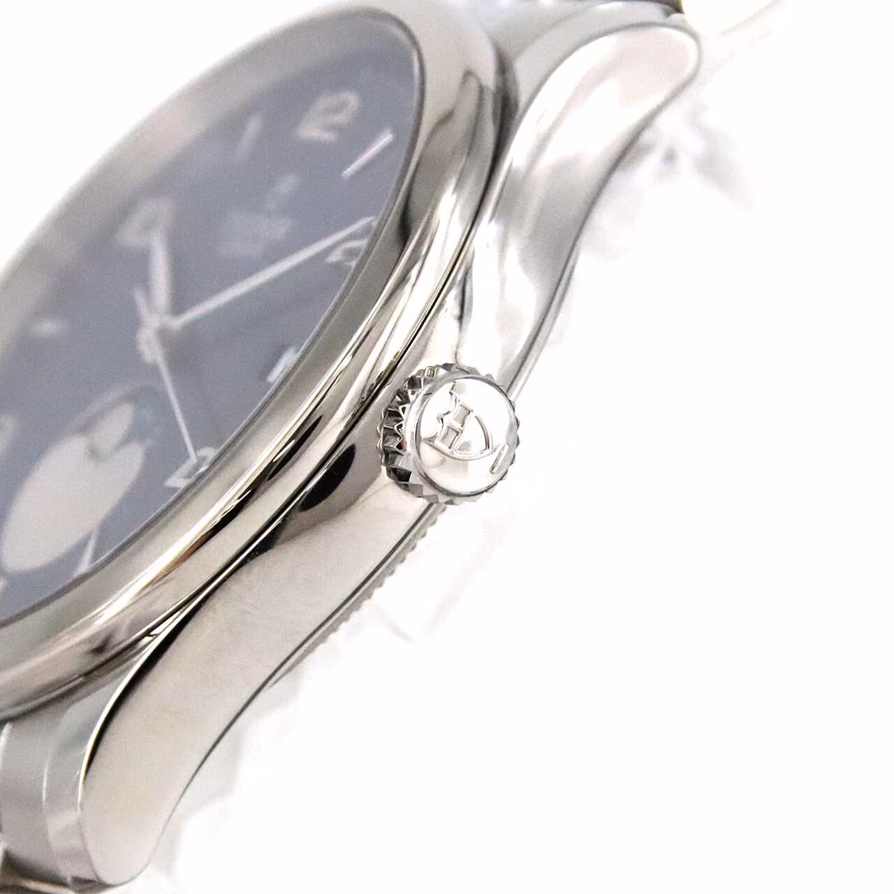 Steel bracelet watch with a round polished case and light dial.