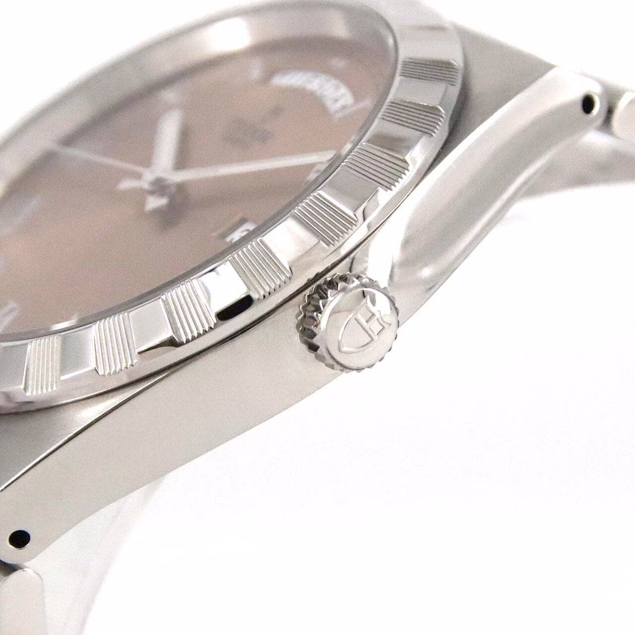 Product photograph of a steel bracelet watch with a fluted bezel.